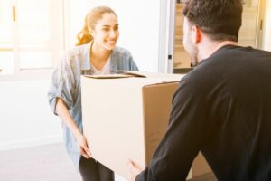 Smiling woman moving box
