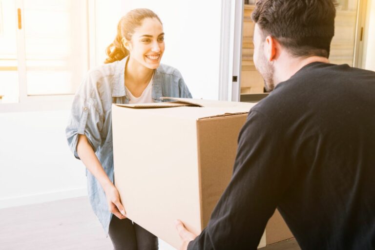 Smiling woman moving box